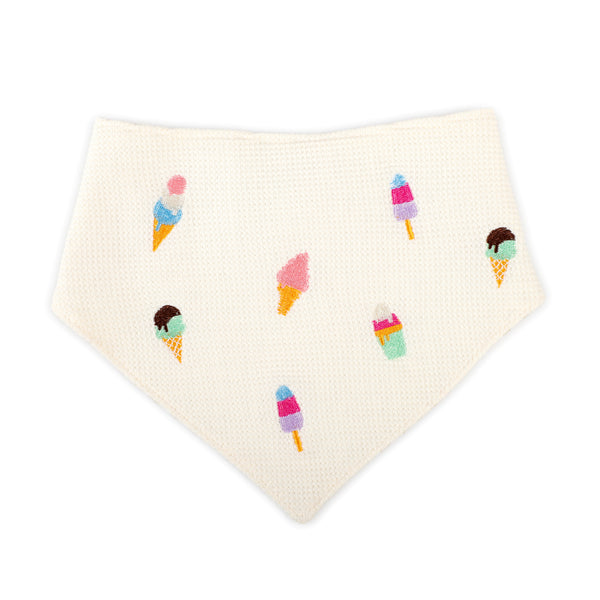 An off-white textured bandana bib featuring a playful print of colorful ice cream cones and popsicles, displayed on a clean white background.
