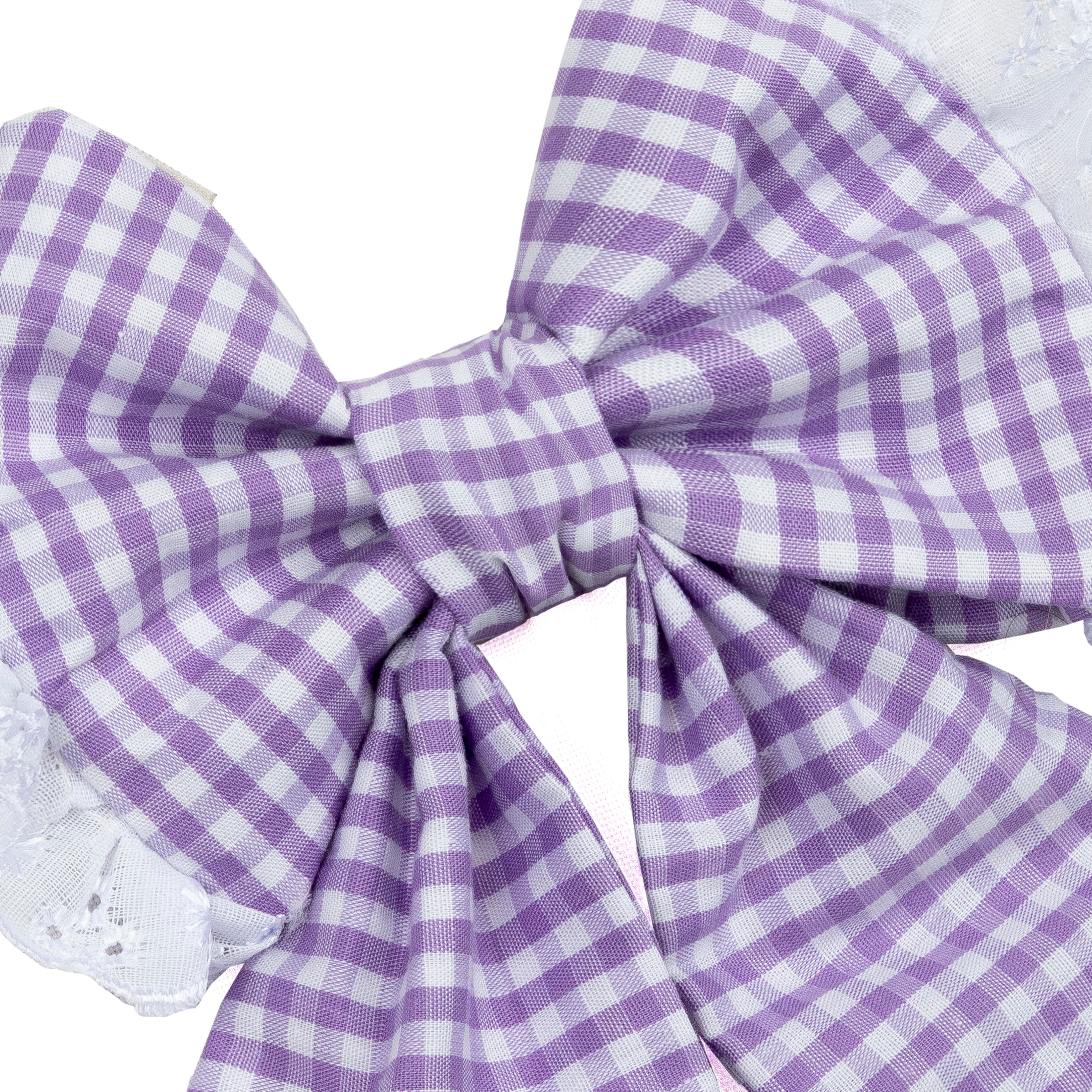 A large dog bow in a purple and white gingham check pattern, shown close-up against a white background with a hint of white lace at the edges.