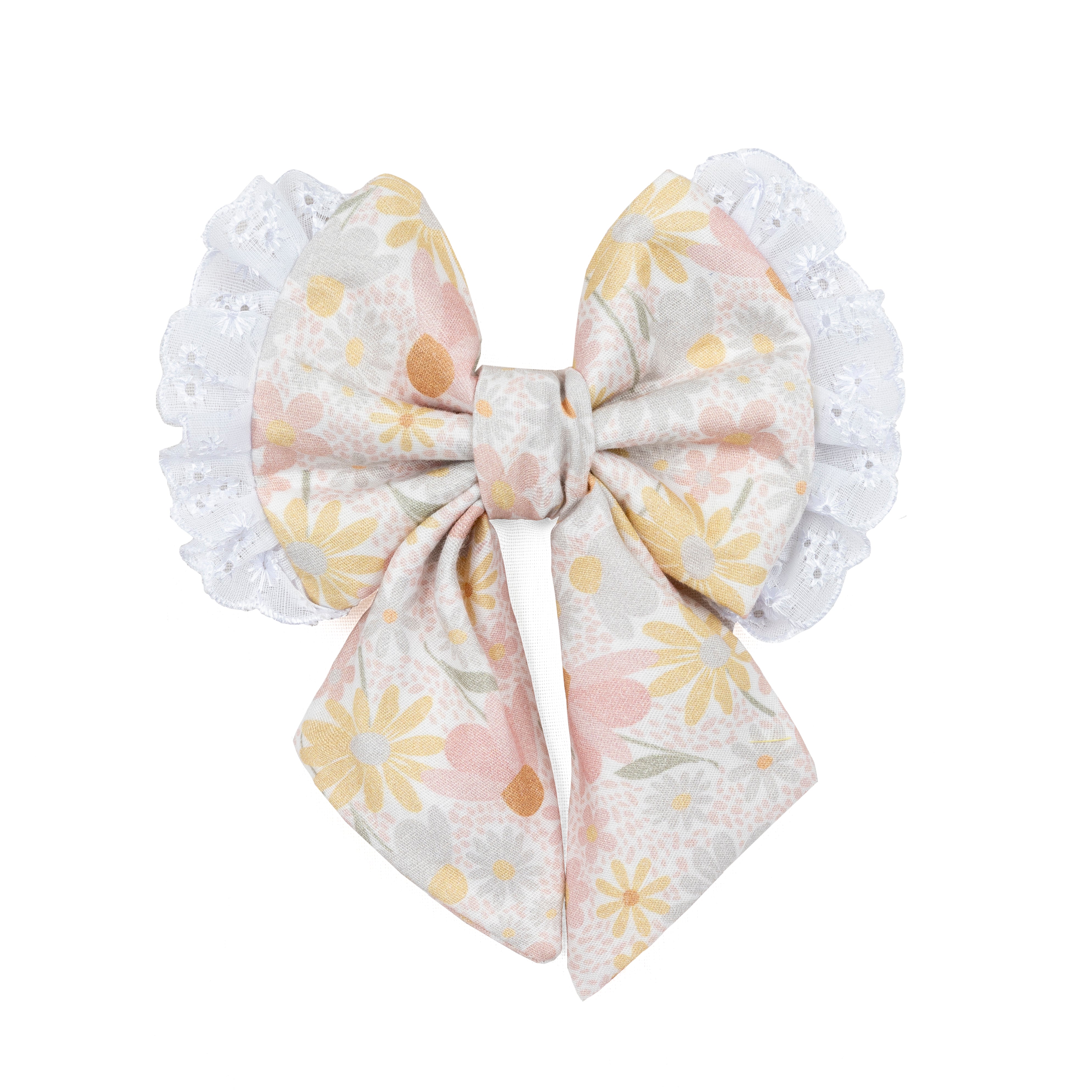 A decorative dog  bow featuring a pastel floral print with yellow, pink, and white flowers on a light gray background, finished with white lace trim on both sides.
